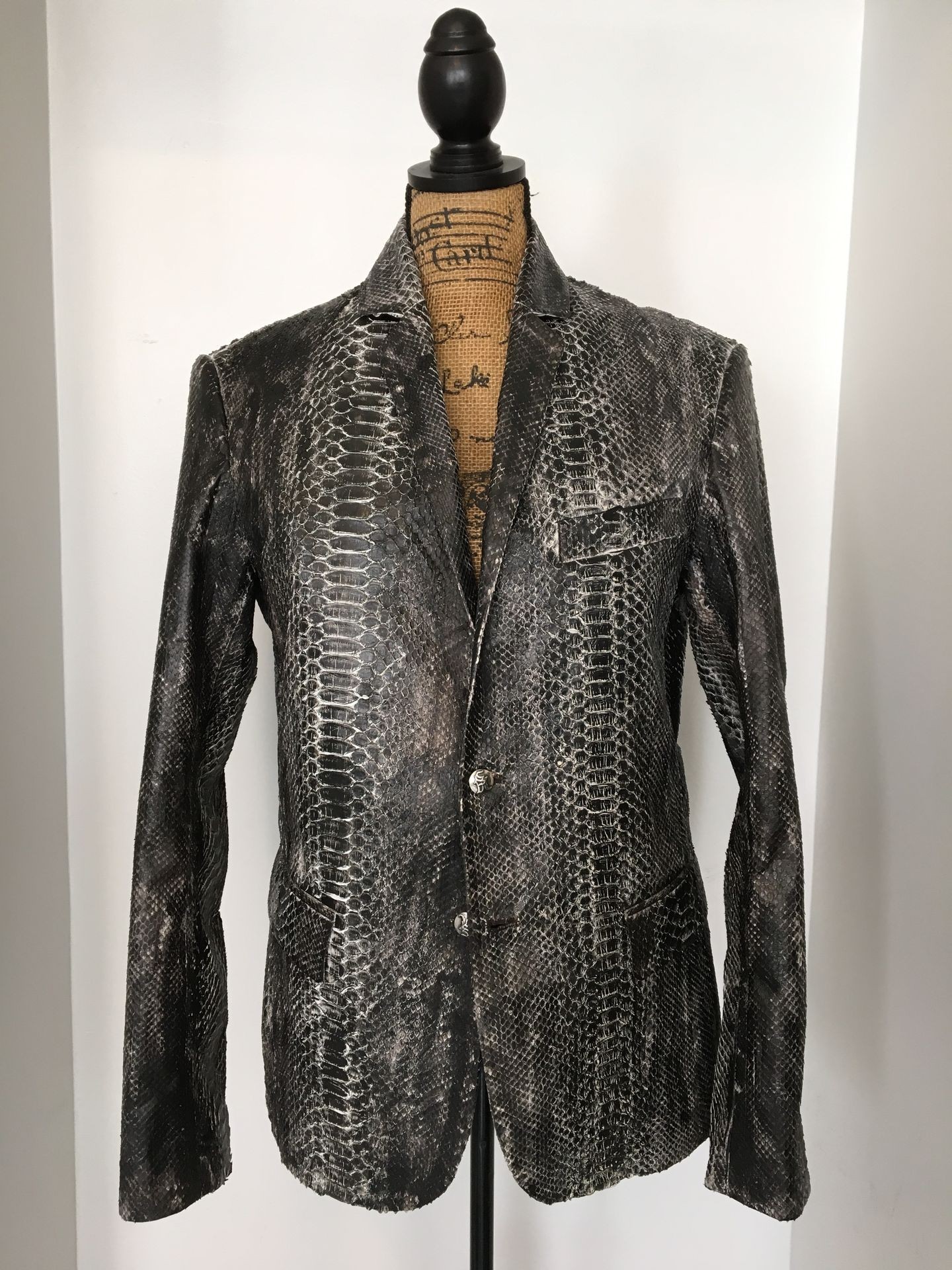 Tailored snake print jacket on a mannequin against a plain white background.